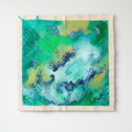 Green and turquoise abstract artwork with navy marks and a cream border, digitally staged on a white wall